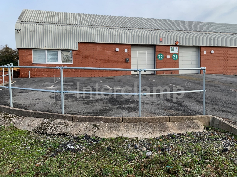 Industrial car park guardrail constructed using Interclamp key clamp fittings and tube, providing a safe and secure barrier for vehicles.